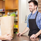 A woman speaking to a grocery store check-out clerk